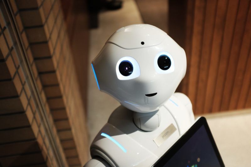 AI robot looking at camera in warehouse