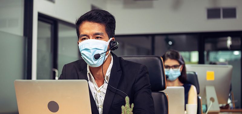 Young telephone operator with headset wear protection face mask against coronavirus, Customer service executive team working at office