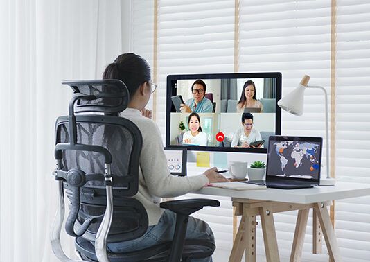 Business woman talking about sale report in video conference.Asian team using laptop and tablet online meeting in video call.Working from home,Working remotely and Self isolation at home