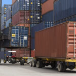 shipping crates moving at container port supply chain