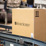 health care distributor Henry Schein box on conveyor belt