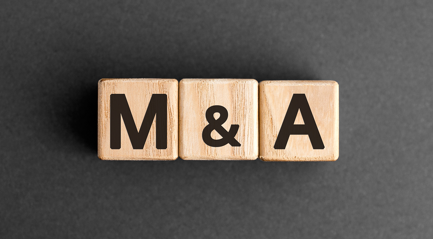 M&A - acronym from wooden blocks with letters, mergers and acquisitions M&A concept,  top view on grey background