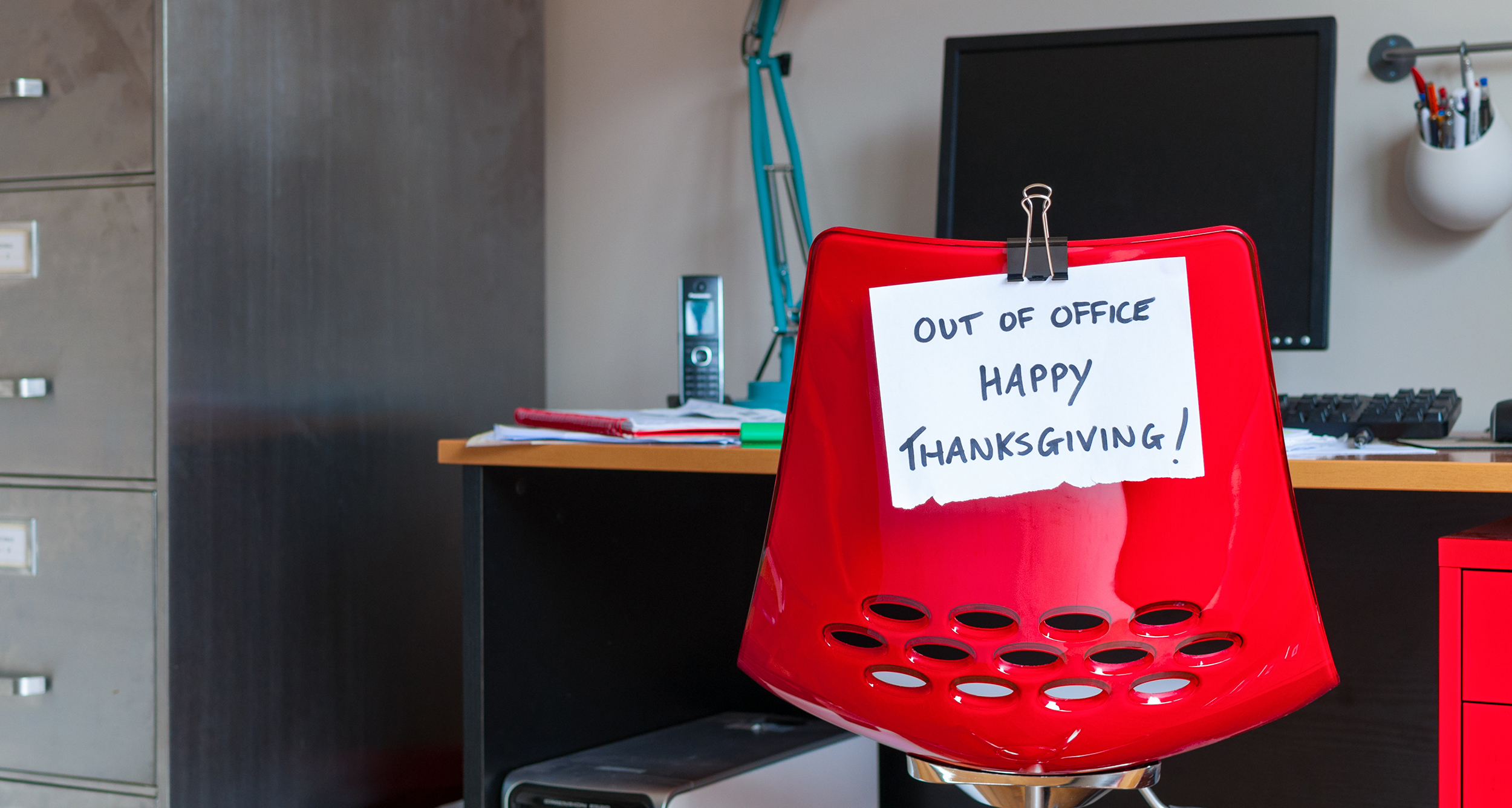 Employee leaves note on back of office chair: Out of Office. Happy Thanksgiving!