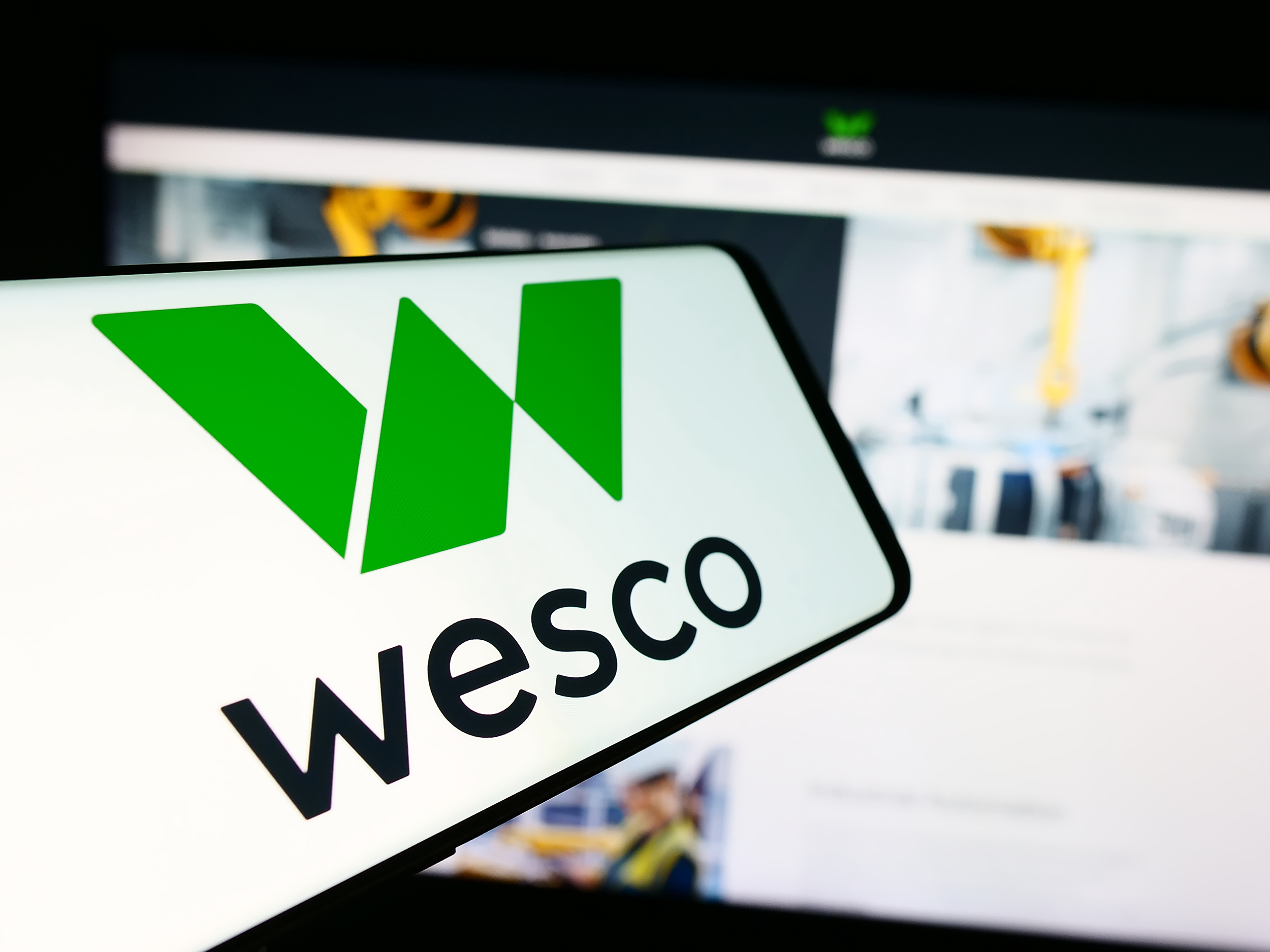 Stuttgart, Germany - 07-05-2024: Mobile phone with logo of American electronics company WESCO International Inc. in front of business website. Focus on center of phone display.