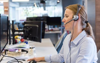 female customer support phone operator with headset  at workplace