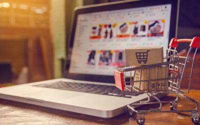 Shopping online concept - Parcel or Paper cartons with a shopping cart logo in a trolley on a laptop keyboard. Shopping service on The online web. offers home delivery.