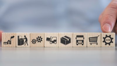 Concept of SCM with icons on wooden cubes