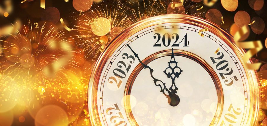 Vintage gold clock New Year 2024 with confetti, golden bokeh lig