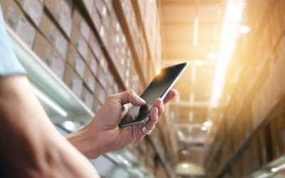 Person in warehouse using cellphone to automate processes