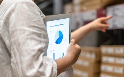 man holding tablet with pie chart in warehouse