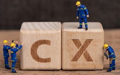 Customer Experience in product and service concept, miniature people workers with blue team uniform building cube wooden block with acronym CX on table with blackboard, user review or feedback.