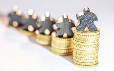 stacks of gold coins with people-shaped silver figures on top